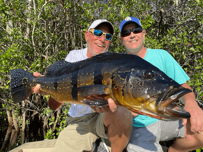 Corporate Amazon Fishing Retreats Business professionals enjoying an Amazon fishing expedition and team retreat